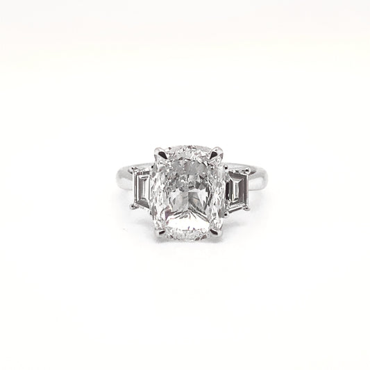 Nekta New York elegant three stone cushion cut ring with a large central diamond and two side stones